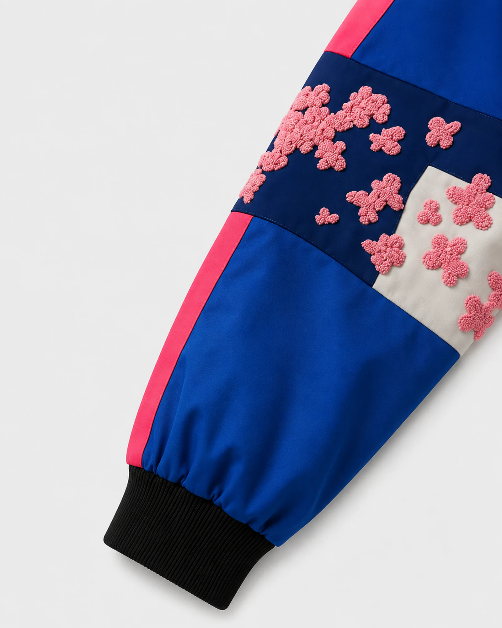 Detail of the embroidered sleeve and pink side stripe